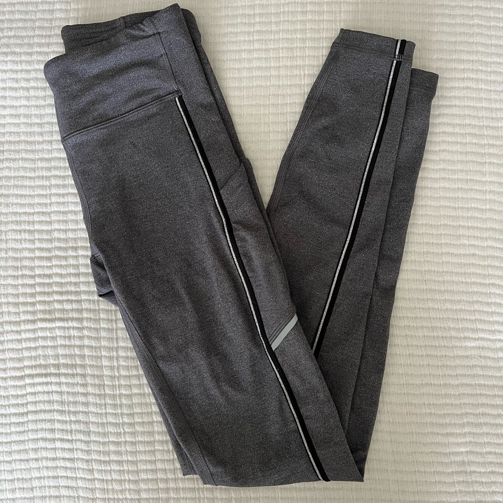 Lululemon leggings. Size 4. Gray with silver stripes down legs.